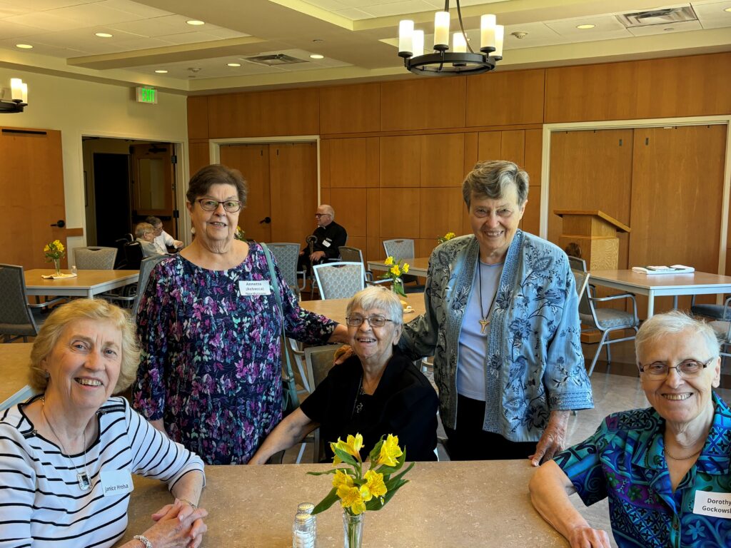 Former members Janice Hreha, Annette Nordstrom, and Dorothy Gockowski pose with Sisters Mary Lou Dummer, Paula Hagen